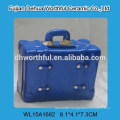 Colorful ceramic piggy bank in suitcase shape